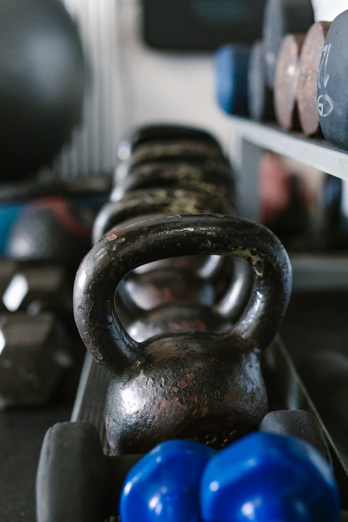 A close view of kettlebells and weights, showcasing essential gym equipment for strength training.